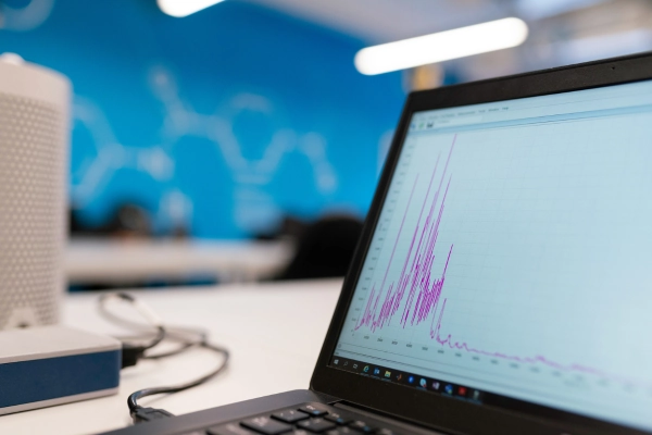 Laptop displaying data analysis graph in a modern tech workspace