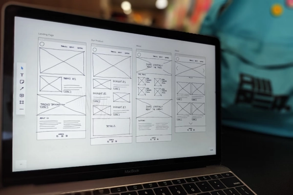 Digital wireframe designs displayed on a laptop screen