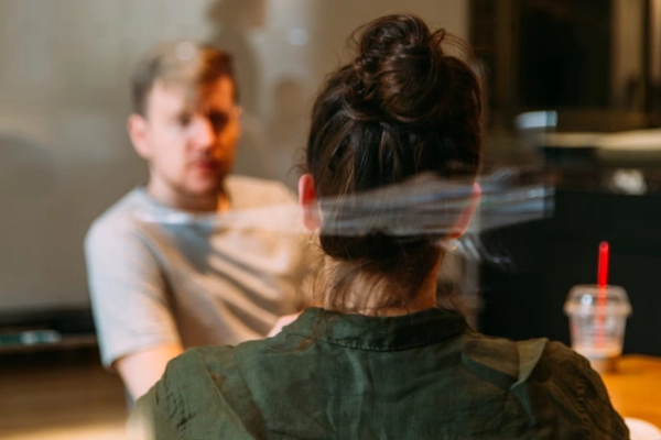 Two people in a CTO interview, one facing the camera from behind, with a blurred focus on the person in front