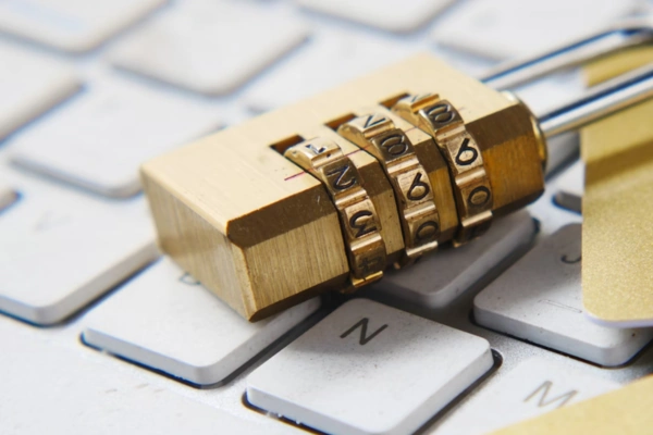 Combination lock placed on a computer keyboard, symbolizing digital security and data protection