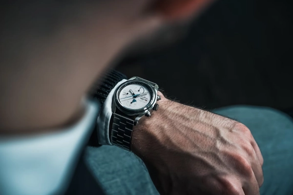 Man checking time on a wristwatch, suggesting urgency or pressure