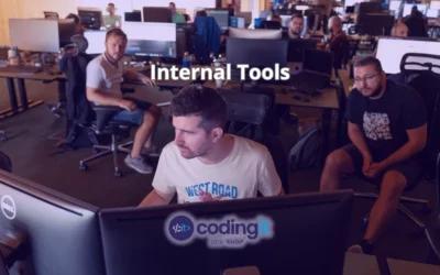Developers working in an open office, focused on internal tools