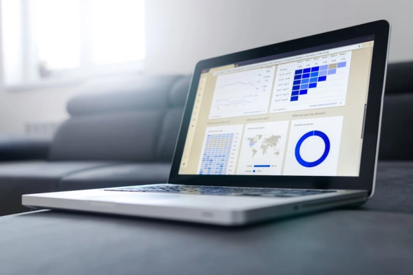 Laptop showing analytics dashboards with charts and metrics