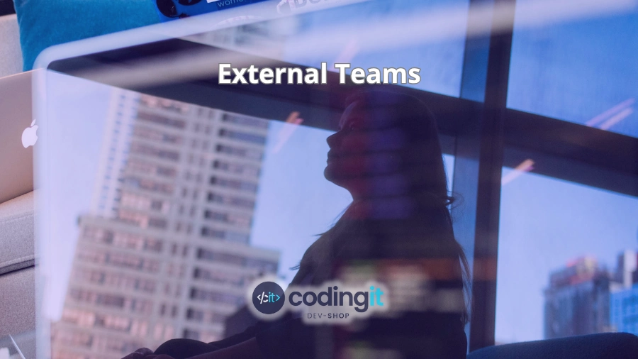 Reflection on a laptop screen of a professional in an office window with the text “External Teams” and the CodingIT logo
